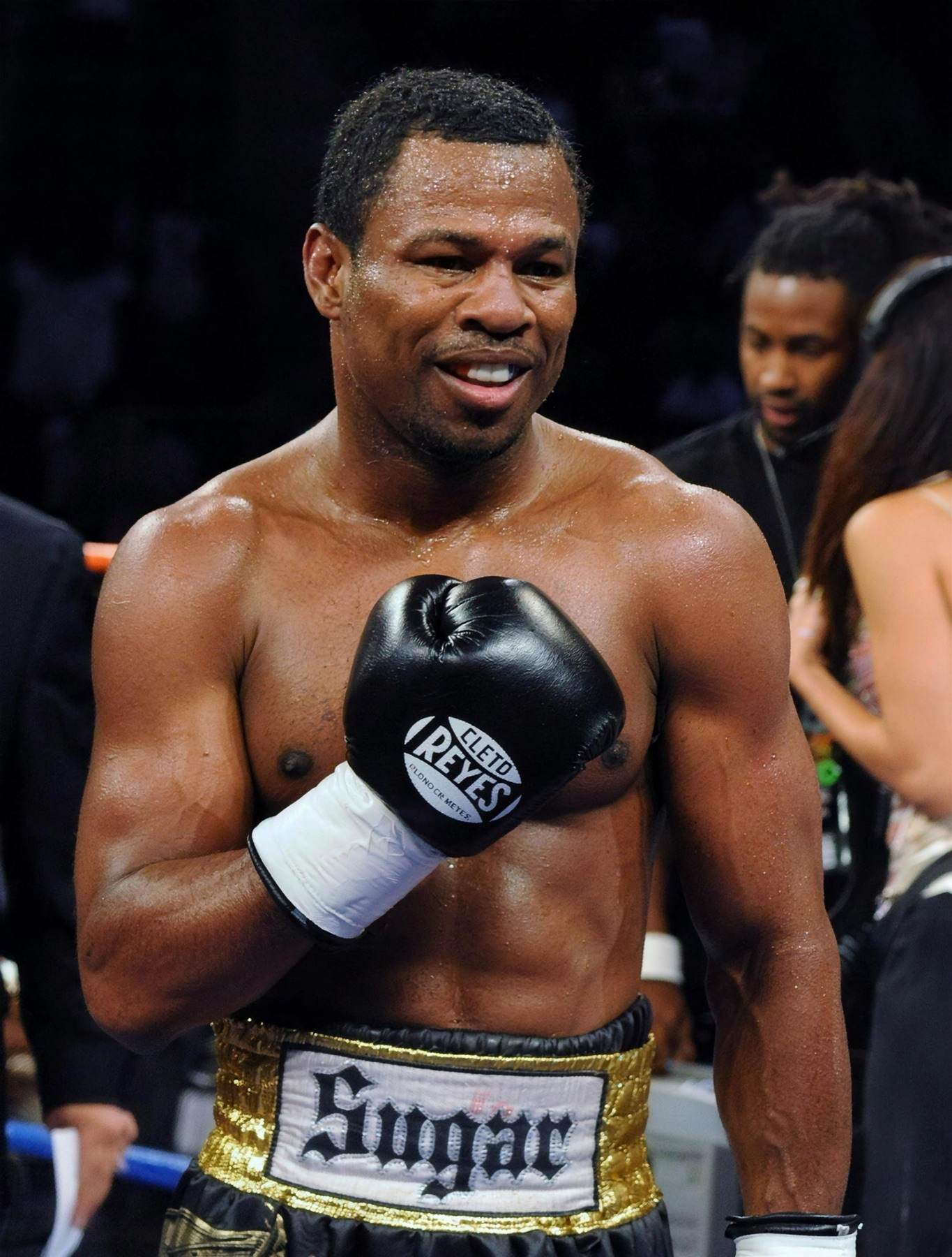 Shane Mosley after a fight, gloves still on, smiling through the sweat