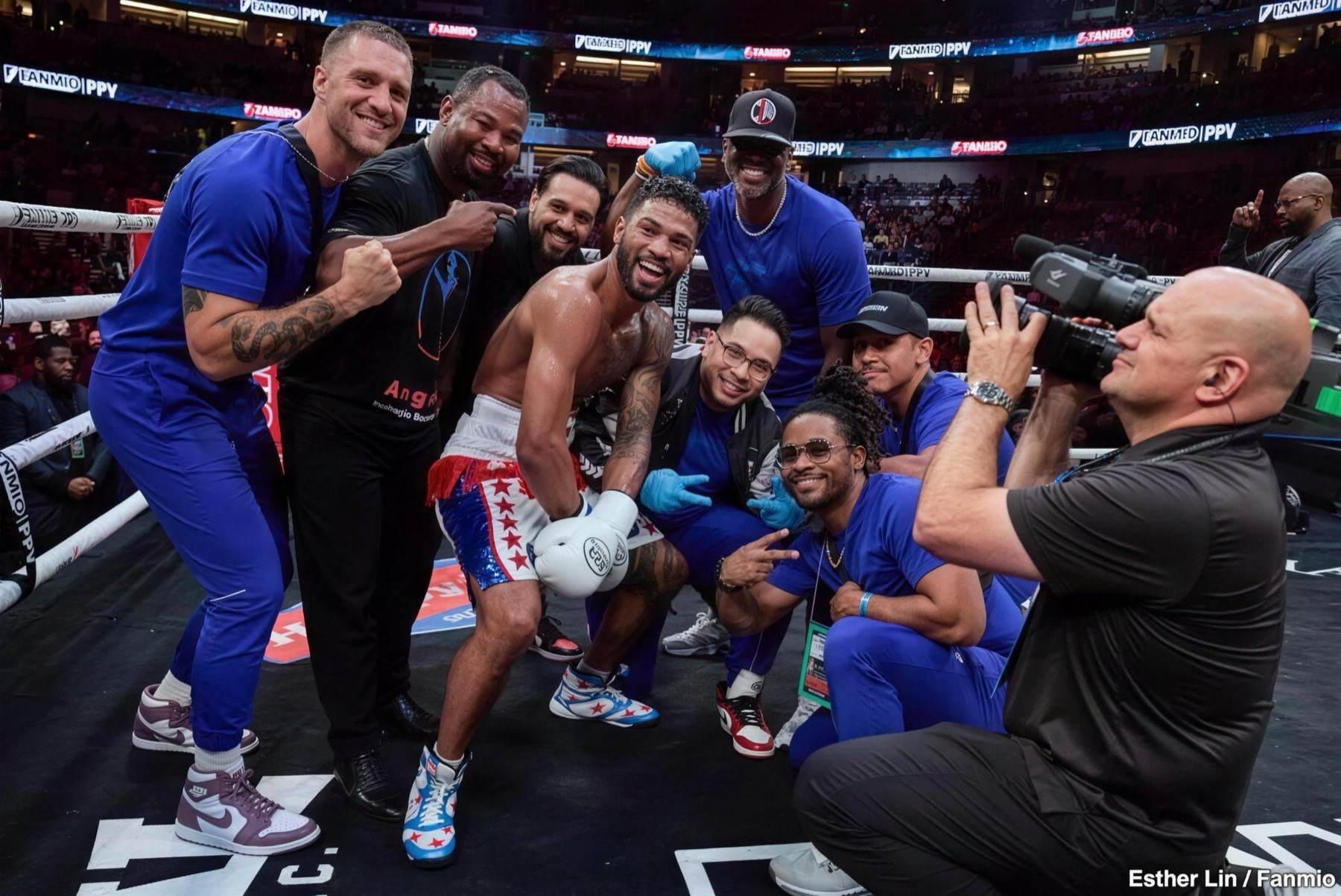 Shane Mosley celebrating in the ring with Shane Mosley Jr. and the team after a win